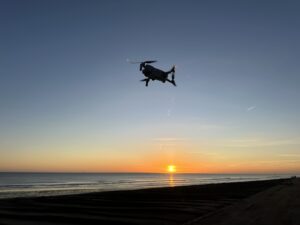 Drone flying over sands at sunrise
