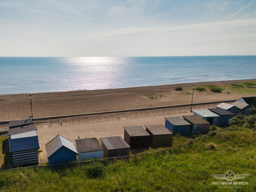Sutton on Sea Beach huts looking out to a sunny North Sea